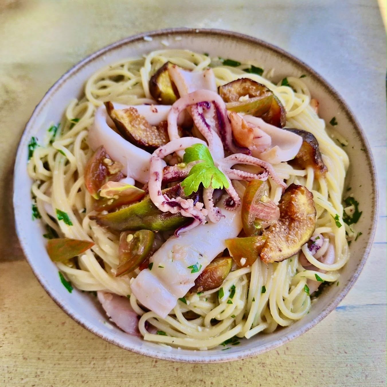 Fresh pasta with red squid and roasted figs